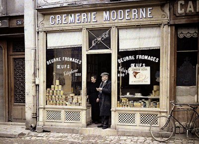 Couple on the doorstep of Le Foll dairy, Reims, Marne, France, 1917 by Fernand Cuville